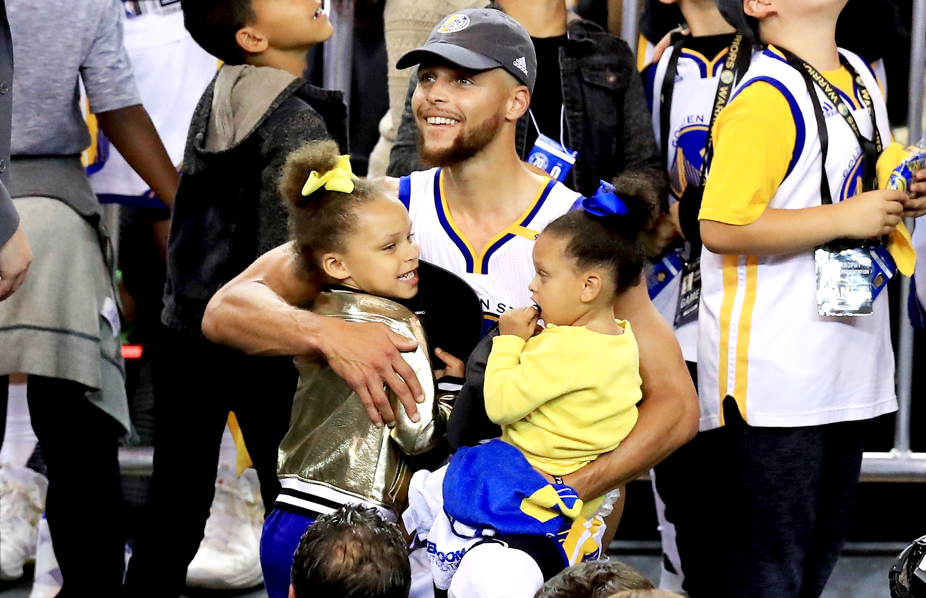 Stephen Curry #30 of the Golden State Warriors celebrates holding his daughters Riley and Ryan after defeating the Cleveland Cavaliers 129-120 in Game 5 to win the 2017 NBA Finals at ORACLE Arena on June 12, 2017 in Oakland, California.