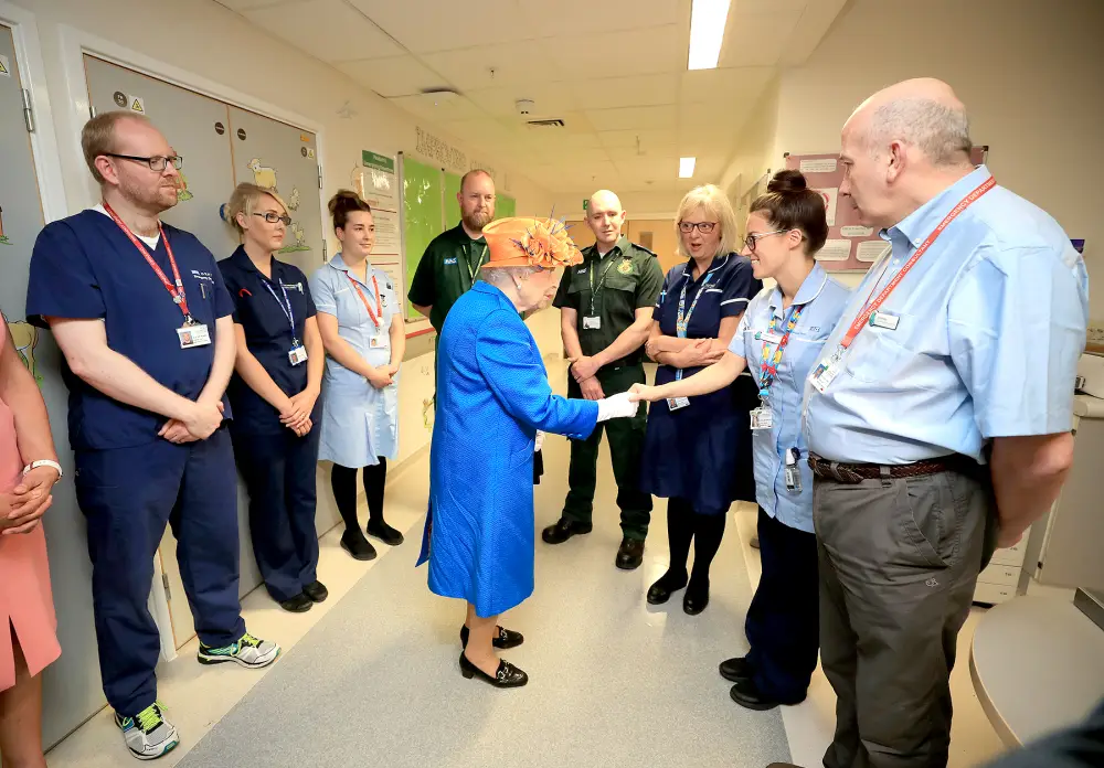 Queen Elizabeth II shakes hands with a nurse during a visit to the Royal Manchester Children's Hospital on May 25, 2017 in Manchester, England.