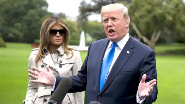 U.S. President Donald Trump, right, speaks to members of the media as First Lady Melania Trump stands before boarding Marine One on the South Lawn of the White House in Washington, D.C., U.S., on Friday, Oct. 13, 2017. Trump plans to visit the U.S. Secret Service training facility in Beltsville, Maryland.