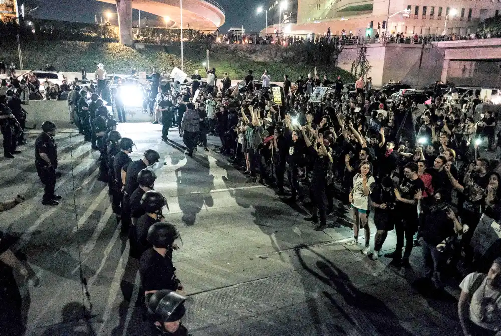 Protesters (right) in Los Angeles confront police on Nov. 9, 2016, as they shut down the 101 Freeway, a major thoroughfare in the city, following a rally to protest Donald Trump's election to the presidency of the United States. Protesters burned a giant orange-haired head of Donald Trump in effigy, lit fires ins the streets and blocked traffic lanes as rage over the billionaire's election victory spilled onto the streets of U.S. cities. From New York to Los Angeles, thousands of people in around 10 cities rallied against the president-elect a day after his stunning win.